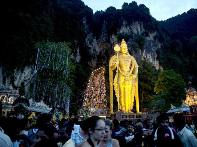 Hindu devotees make their way towards the Batu Caves to perform their religious rites before sunrise during the Thaipusam Festival on the outskirts of Kuala Lumpur. The Hindu festival of Thaipusam, which commemorates the day when Goddess Pavarthi gave her son Lord Muruga an invincible lance with which he destroyed evil demons, is celebrated by some two million ethnic Indians in Malaysia and Singapore. AFP PHOTO / Saeed KHAN
