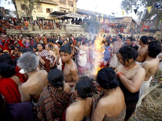Devotees warm themselves by a fire after taking a dip on the final day of the month-long Swasthani festival in the Hanumante River at Bhaktapur, near Kathmandu. The month-long festival, dedicated to God Madhavnarayan and Goddess Swasthani, involves the recitation of folk tales about miraculous feats performed by them in many households. Reuters Photo/Navesh Chitrakar