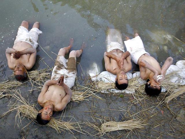 Devotees offer prayers by taking a dip on the final day of the month-long Swasthani festival in the Hanumante River at Bhaktapur, near Kathmandu. The month-long festival, dedicated to God Madhavnarayan and Goddess Swasthani, involves the recitation of folk tales about miraculous feats performed by them in many households. Reuters Photo/Navesh Chitrakar