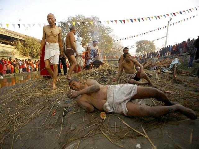 Devotees offer prayers by rolling on the street of Bhaktapur, near Kathmandu. The month-long Swasthani festival, dedicated to God Madhavnarayan and Goddess Swasthani, involves the recitation of folk tales about miraculous feats performed by them in many households. Reuters Photo/Navesh Chitrakar
