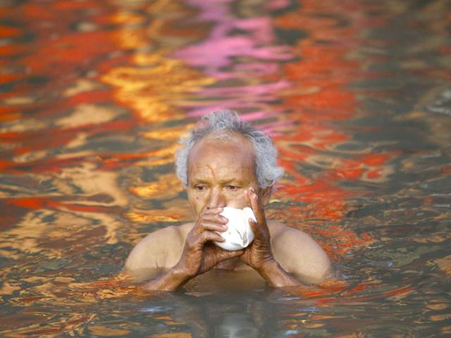 A devotee offers prayer by blowing a conch on the final day of the month-long Swasthani festival in the Hanumante River at Bhaktapur, near Kathmandu. The month-long festival, dedicated to God Madhavnarayan and Goddess Swasthani, involves the recitation of folk tales about miraculous feats performed by them in many households. Reuters Photo/Navesh Chitrakar