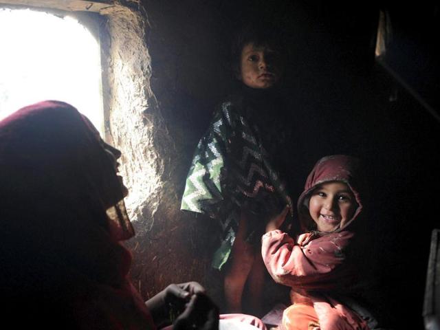Internally displaced Afghan children from Helmand province sit inside a mud shelter for the displaced at the Charhi Qambar refugee camp on the outskirts of Kabul. Fleeing NATO bombardment and Taliban intimidation, thousands of Afghans in refugee camps in the capital Kabul face a new enemy: an unusually bitter winter that is killing their children. AFP Photo/ Shah Marai