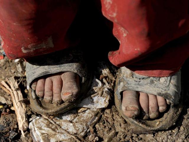 The feet of an internally displaced Afghan girl from Helmand province are pictured outside a mud shelter for the displaced at the Charhi Qambar refugee camp on the outskirts of Kabul. Fleeing NATO bombardment and Taliban intimidation, thousands of Afghans in refugee camps in the capital Kabul face a new enemy: an unusually bitter winter that is killing their children. AFP Photo/ Shah Marai
