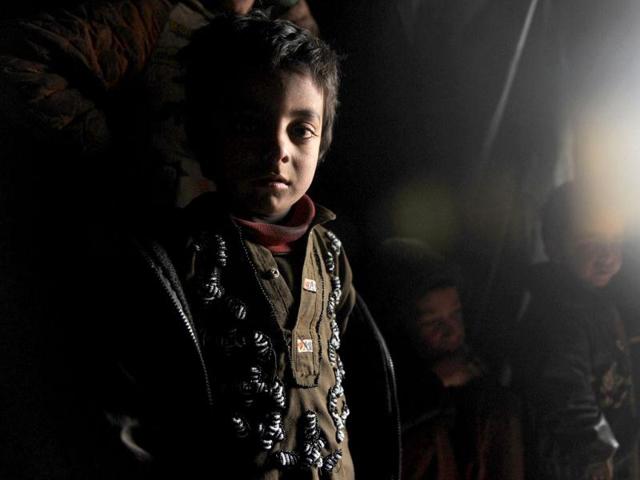 An internally displaced Afghan girl from Helmand province is pictured inside a mud shelter for the displaced at the Charhi Qambar refugee camp on the outskirts of Kabul. Fleeing NATO bombardment and Taliban intimidation, thousands of Afghans in refugee camps in the capital Kabul face a new enemy: an unusually bitter winter that is killing their children. AFP Photo/ Shah Marai