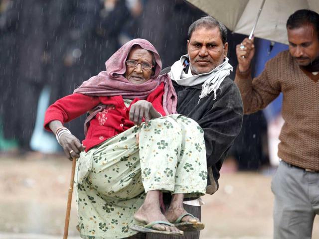 A-person-carries-an-elderly-woman-after-she-cast-her-vote-in-Gonda-district-in-the-Indian-state-of-Uttar-Pradesh-AP-Photo-Rajesh-Kumar-Singh A-person-carries-an-elderly-woman-after-she-cast-her-vote-in-Gonda-district-in-the-Indian-state-of-Uttar-Pradesh-AP-Photo-Rajesh-Kumar-Singh