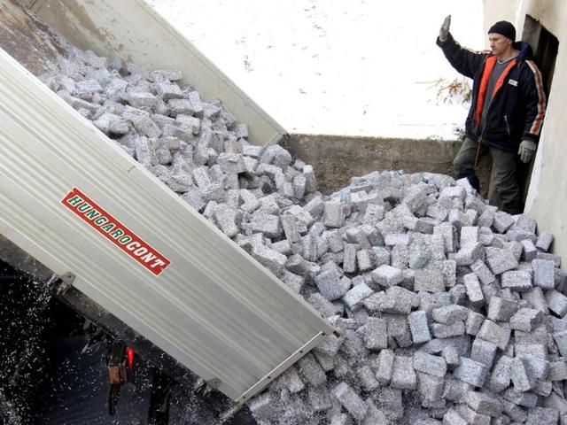 Tons of shredded and compressed banknotes are unloaded from a truck at the Foundation to Help Autism in Miskolc, eastern Hungary. Reuters/Laszlo Balogh