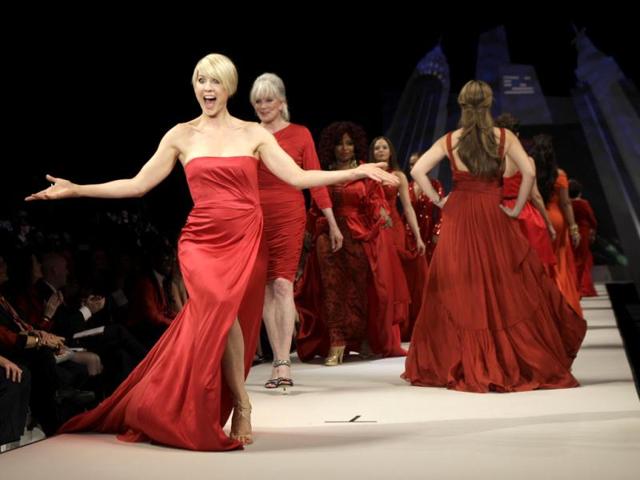 Actress Jenna Elfman, wearing a dress designed by Alberta Ferretti, reacts on the runway with other celebrity models, including Linda Evans, second from right, during the Heart Truth Red Dress fashion show in New York. AP Photo/Kathy Willens