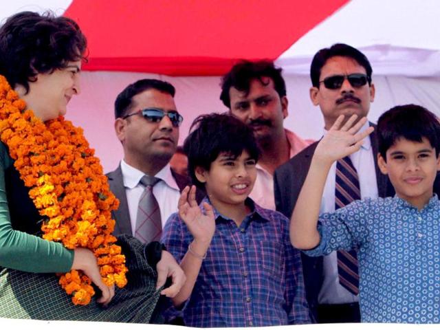 Priyanka Gandhi Vadra watches her kids wave to the crowd at an election campaign rally in Rasulpur, Amethi. PTI/Atul Yadav