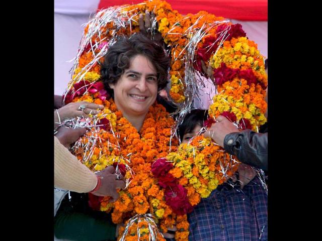 Priyanka Gandhi Vadra is garlanded at an election campaign rally in support of Congress party in Rasulpur, Amethi. PTI/Atul Yadav