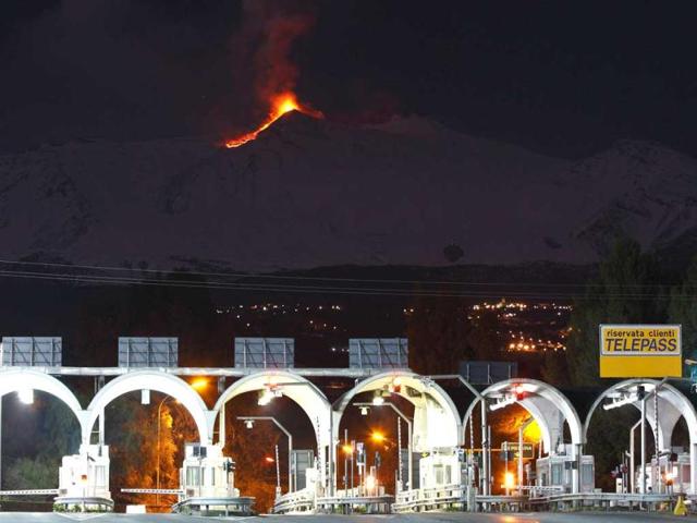 A highway toll gate is seen as Mount Etna spews lava on the southern Italian island of Sicily. Mount Etna is Europe's tallest and most active volcano. REUTERS/Antonio Parrinello