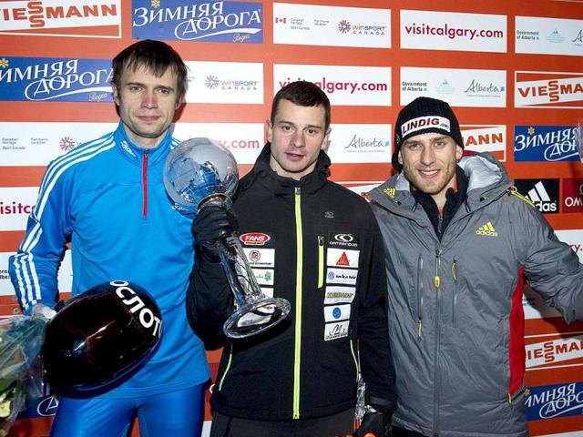 Martin Dukurs (C) of Latvia celebrates his win and winning the overall world cup title of the men's skeleton race with Alexander Tretiakov (L) of Russia who finished second and Frank Rommel of Germany who finished third at the FIBT Bobsleigh and Skeleton World Cup competition in Calgary, Alberta. Reuters