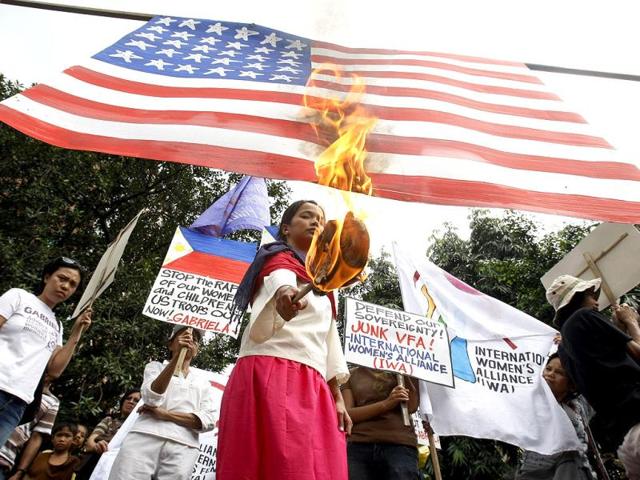 Women protesters burn a mock American flag during a rally near the US Embassy in Manila in the Philippines to protest the alleged shift of focus in US foreign policy from Iraq and Afghanistan to the Asia Pacific under the so-called Pacific Century. AP