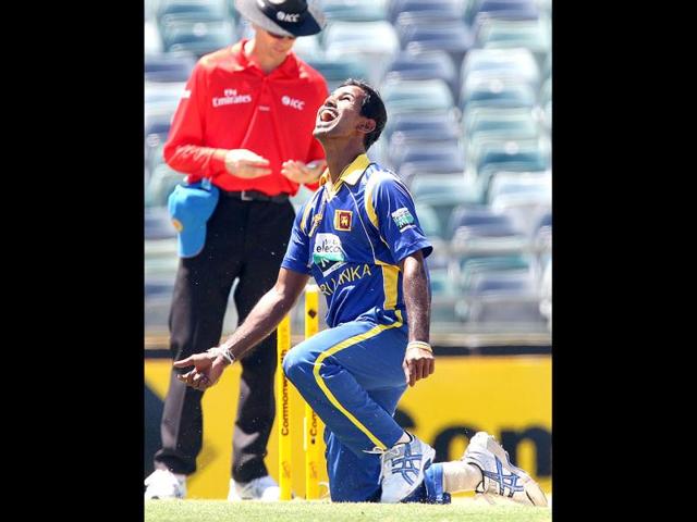 Nuwan Kulasekara reacts after he catched the ball to bowl Australian batsman Mike Hussey (unseen) during the Tri Nations ODI Cricket Series match in Perth. AFP