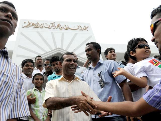 Former Maldives president Mohamed Nasheed (C) greets people after Friday prayers in Male. Nasheed demanded fresh elections after being ousted in what he called a coup d'etat. AFP photo
