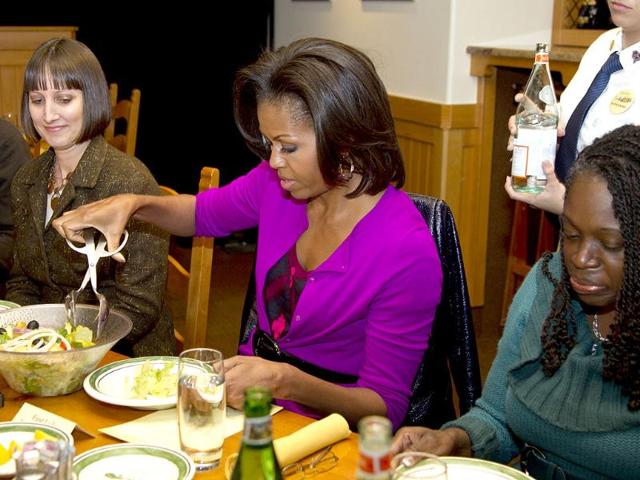 US First lady Michelle Obama serves herself some salad during a roundtable dinner at an Olive Garden restaurant in Fort Worth, Texas, during her three day national tour celebrating the second anniversary of Let's Move. AP/Carolyn Kaster