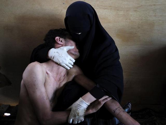 Samuel Aranda of Spain, a photographer working for The New York Times, has won the World Press Photo of the Year 2011 with this picture of a woman holding a wounded relative during protests against president Saleh in Sanaa, Yemen. REUTERS/Samuel Aranda
