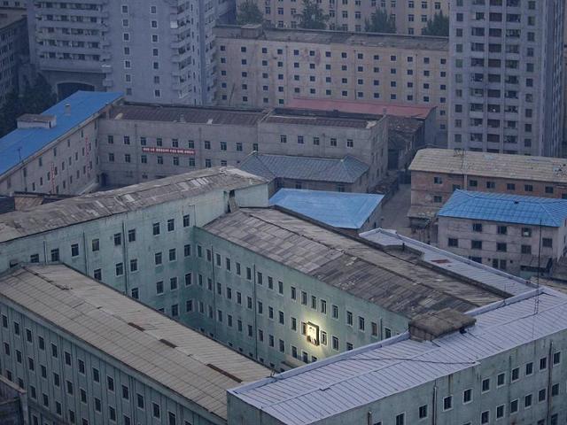 Damir Sagolj of Bosnia and Herzegovina, a Reuters photographer based in Thailand, has won the first prize Daily Life Singles with this photograph of a picture of North Korea's founder, Kim Il-sung, decorating a building in the capital Pyongyang. REUTERS/Damir Sagolj