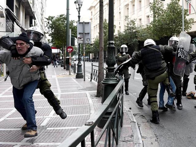 Protesters clash with riot police during a 48-hour general strike in Athens. Greek protesters threw stones and firebombs at riot police who responded with tear gas in Athens on February 10 as clashes erupted on the sidelines of a protest against new austerity cuts. AFP / ARIS MESSINIS