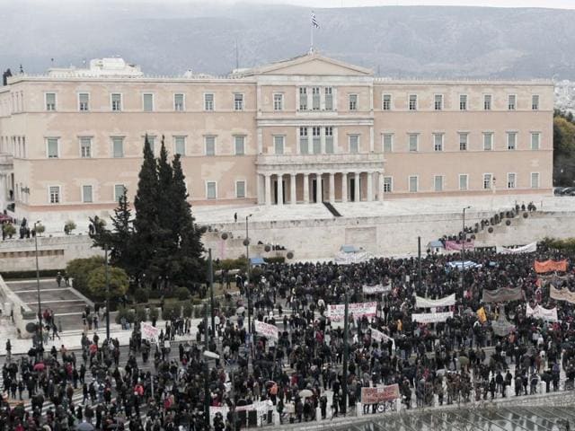 Demonstrators rally in front of Parliament in Athens. Thousands took to the streets of Athens as unions launched a two-day general strike against planned austerity measures a day after Greece's crucial international bailout was put in limbo by its partners in the 17-nation eurozone. Clashes broke out in Syntagma Square, outside Parliament, as dozens of hooded youths threw fire bombs and stones at police, who responded with tear gas. AP /Dimitri Messinis