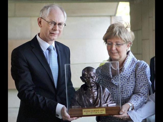 Herman van Rompuy, President of the council of the European Union and his wife Geertrui Windels receive a bust of Mahatma Gandhi after paying homage at Rajghat in New Delhi. PTI/Subhav Shukla