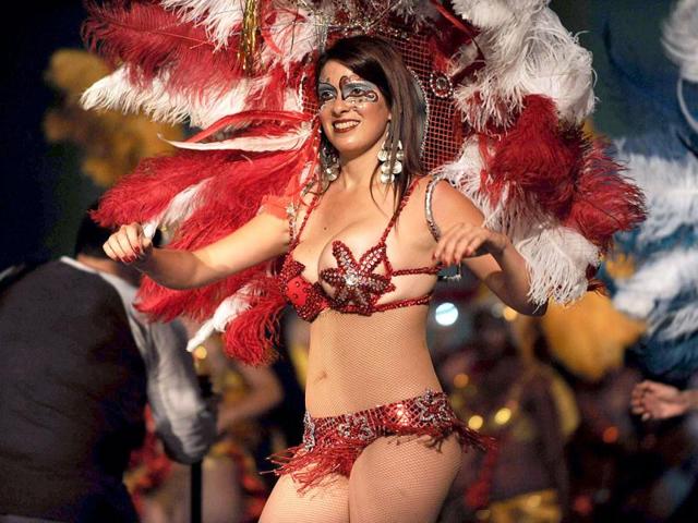 A dancer performs during the first night of the "Llamadas" (Calls) parade of the carnival of Montevideo. The "Llamadas" is Uruguay's biggest carnival parade, in which "comparsas" -- groups of dancers and drummers of the traditional "candombe" music -- compete for two nights of parades. AFP PHOTO/PABLO PORCIUNCULA