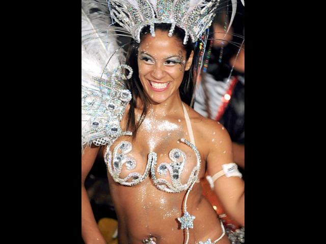 A dancer performs during the first night of the "Llamadas" (Calls) parade of the carnival of Montevideo. The "Llamadas" is Uruguay's biggest carnival parade, in which "comparsas" -- groups of dancers and drummers of the traditional "candombe" music -- compete for two nights of parades. AFP PHOTO/PABLO PORCIUNCULA