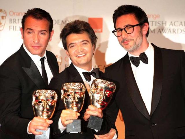 The Artist crew with their awards: (L-R) Actor Jean Dujardin, Producer Thomas Langmann, Director Michel Hazanavicius.