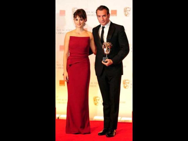 Best Actor award presenter poses Penelope Cruz with the winner Jean Dujardin for his film The Artist.
