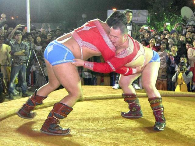 Mongolian wrestlers in action during an exhibition sumo wrestling match at the 19th International Guwahati Trade Fair 2012 in Guwahati on Sunday. (PTI Photo)