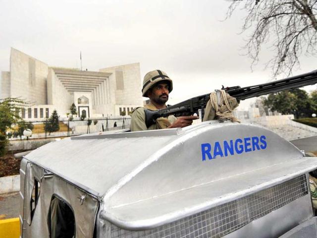 A Pakistani paramilitary soldier stands guard outside the Supreme Court building in Islamabad. Pakistani Prime Minister Yousuf Raza Gilani has been indicted for contempt in Supreme Court, for his refusal to re-open graft cases against President Asif Ali Zardari. (AFP Photo)