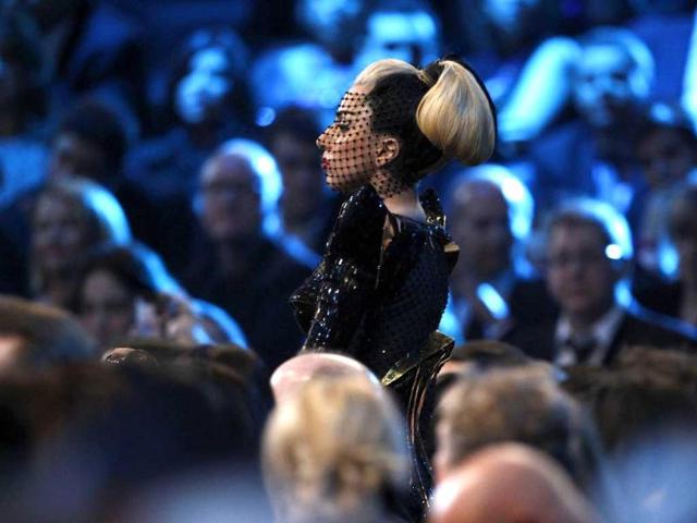 Lady Gaga donned a black Chanel gown adorned with silver chains and dramatic net over her face.