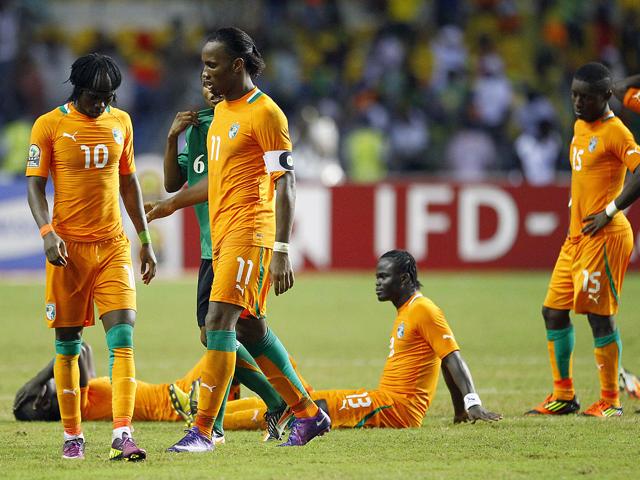 Ivory Coast's Gervinho, left, and captain Didier Drogba, second left, react with teammates after they lost on penalty kicks against Zambia during their African Cup of Nations final soccer match at Stade de L'Amitie in Libreville, Gabon. (AP Photo/Francois Mori)