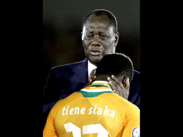 Ivory Coast President Alassane Ouattara consoles player Siaka Tiene after Ivory Coast's loss to Zambia in their African Cup of Nations final soccer match at Stade de l'Amitie in Libreville, Gabon. (AP Photo/Rebecca Blackwell)