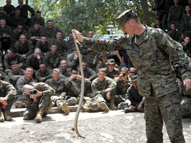 A US Marine holds a cobra during a jungle survival program as part of the annual Cobra Gold 2012 combined military exercise at a navy base in Sattahip. AFP Photo/Pornchai Kittiwongsakul