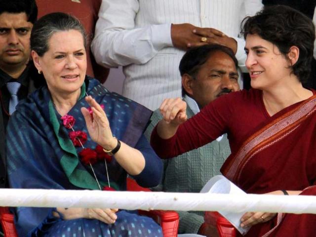 Priyanka Gandhi Vadra shares a lighter moment with her mother and UPA Chairperson Sonia Gandhi at an election campaign in rally in Raebareli. PTI Photo/Atul Yadav