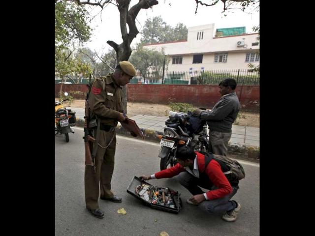 A policeman checks the contents of a bag carried by a motorcycle rider at a check point near the Israeli embassy in New Delhi. An Israeli embassy car blew up February 13 in the country's capital, injuring an Israeli diplomat and one other person, but it was not immediately known whether the explosion was caused by a bomb, officials said. Israel assailed Iran as the world's "biggest exporter of terror" after two bombs targeted its overseas personnel in India and Georgia, critically wounding one female diplomat in New Delhi. PTI