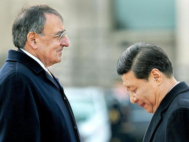 China's Vice President Xi Jinping (R) walks back to the stage after reviewing a guard of honor as US Secretary of Defense Leon E Panetta looks on at the Pentagon in Washington, DC. China's likely next leader Xi Jinping said that Beijing will take concrete steps to improve human rights as he admitted "there is always room for improvement." AFP Photo/Jewel Samad