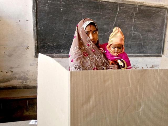 A woman casts her vote inside a polling station in Varanasi. AP Photo/Rajesh Kumar Singh