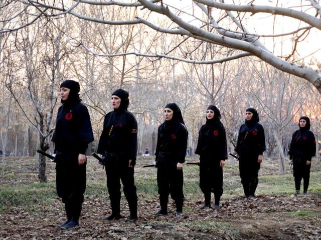 Ninjutsu practitioners prepare for a sword drill as members of various Ninjutsu schools showcase their skills to the media at a park in Karaj. (Reuters/Caren Firouz)
