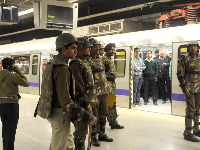 Delhi Metro passengers watch police personnel patrolling a train platform at a metro station during a mock drill conducted by the Delhi Police and Delhi metro authorities in New Delhi. AFP Photo/Raveendran