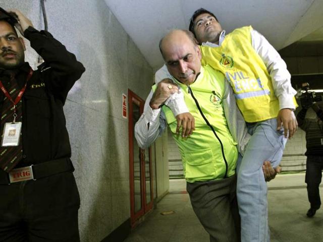 A disaster management official performs a mock rescue during a disaster drill checking the alertness and preparedness of various agencies in the event of a major earthquake, at a metro station, in New Delhi. AP Photo/Saurabh Das