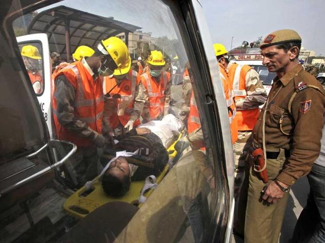 Disaster management officials perform a mock rescue during a disaster drill checking the alertness and preparedness of various agencies in the event of a major earthquake, in New Delhi. AP Photo/Manish Swarup