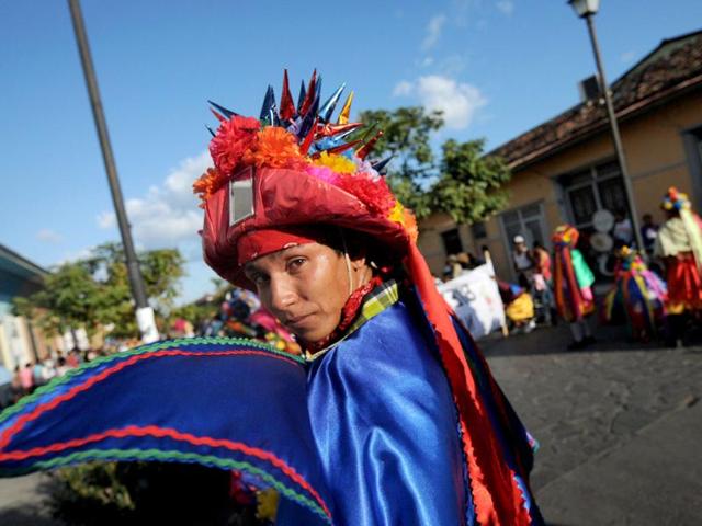 A Nicaraguan man dressed in traditional costumes takes part in the ''Poetry Carnival'' during celebrations of the VIII International Poetry Festival in Granada, about 50 kms south of Managua. AFP Photo/ Elmer Martinez