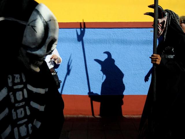 Nicaraguans dressed in traditional costumes take part in the ''Poetry Carnival'' during celebrations of the VIII International Poetry Festival in Granada, about 50 kms south of Managua. AFP Photo/ Elmer Martinez