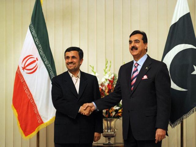Pakistan's Prime Minister Yousuf Raza Gilani (R) shakes hands with Iranian President Mahmoud Ahmadinejad upon his arrival at the Prime Minister House in Islamabad. AFP/Aamir Qureshi