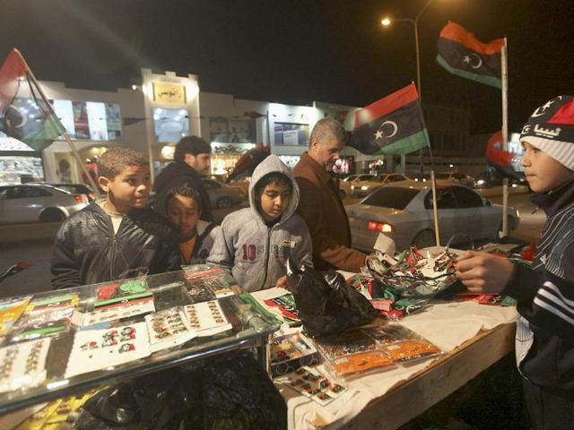 Boys check out a stall with Kingdom of Libya flags on the streets of Benghazito as Libya marks the first anniversary of revolutionary uprising against Muammar Gaddafi. Reuters/Esam Al-Fetori