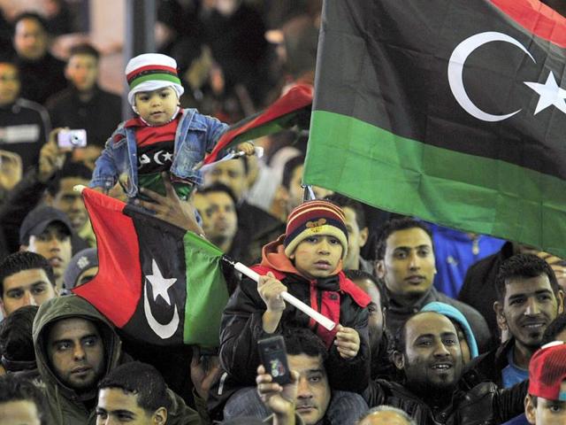 People with the Kingdom of Libya flags gather during a celebration to mark the first anniversary of revolutionary uprising against Muammar Gaddafi. Reuters/Esam Al-Fetori