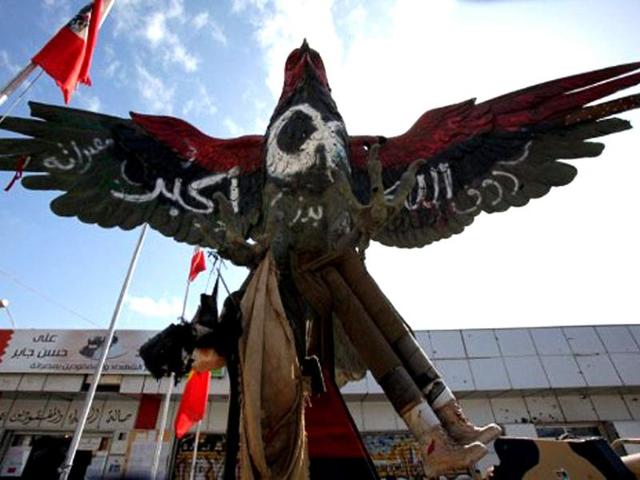 A falcon statue, painted in the colours of the revolutionary flag and covered with the inscription "God is great", is displayed outside the museum set up on Tripoli boulevard in Misrata. One year since the revolution against Muammar Gaddafi erupted, on February 17, 2011, Misrata - Libya's third largest city - is a clear example of the ferocity of the fighting. AFP/Mahmud Turkia