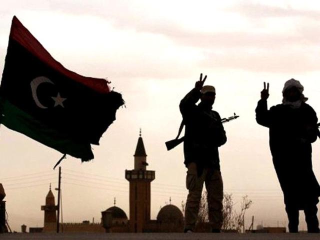 Libyan National Transitional Council (NTC) fighters flash the victory sign as they man a checkpoint south of Bani Walid. AFP/Karim Sahib, File
