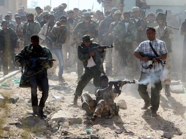 Libyan National Transitional Council (NTC) fighters fire at forces loyal to Muammar Gaddafi during street battles in the neighbourhoods of Dollar and Sirte. AFP/Ahmad Al-Rubaye, File